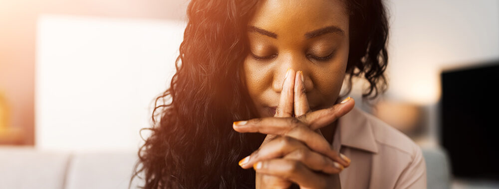 Black-woman-praying-church-steeple-fingers