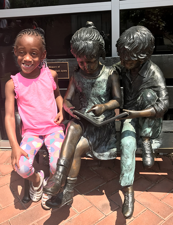 Malia-with-bronze-children-sculptures